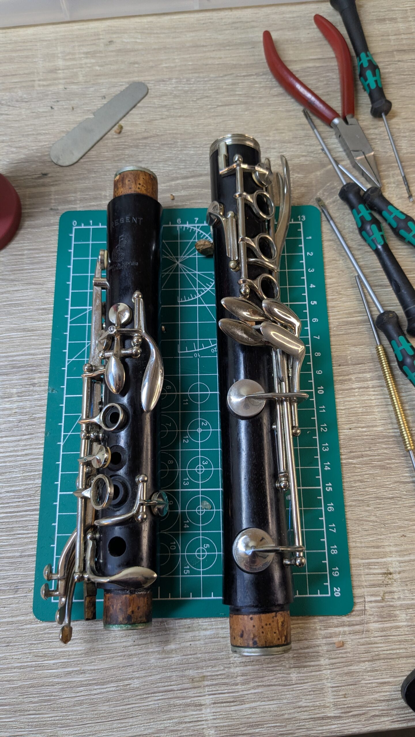 A clarinet being prepared for service, surrounded by hand tools